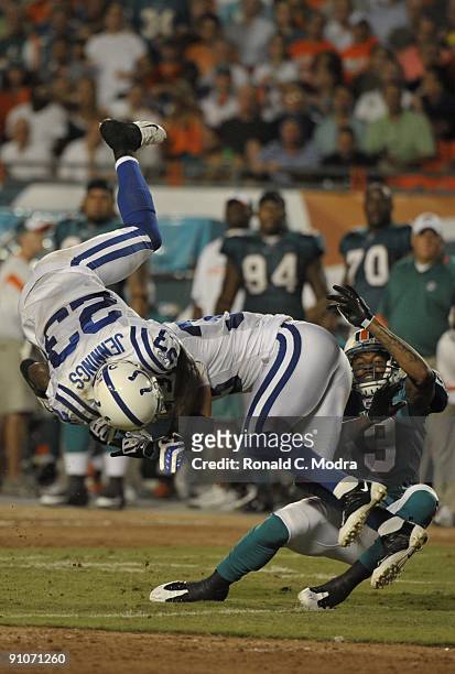 Ted Ginn, Jr. #19 of the Miami Dolphins collides with Tim Jennings and Melvin Bullitt of the Indianapolis Colts going for a pass during a NFL game at...