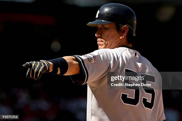 Hideki Matsui of the New York Yankees points to the dugout as he stands on first base in the game with the Los Angeles Angels of Anaheim on September...