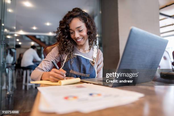happy manager doing the books at a restaurant - plano de atividades imagens e fotografias de stock
