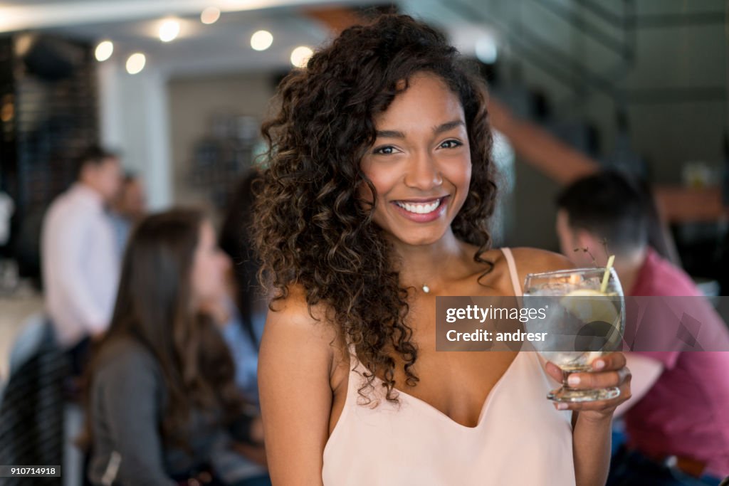 Portrait of a beautiful woman having drinks at a bar