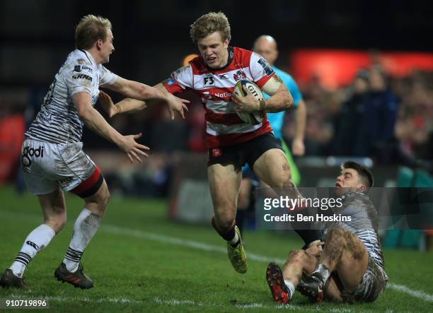 Ollie Thorley of Gloucester is tackled by Luke Price and Reuben Morgan-Williams of Ospreys during the Anglo-Welsh Cup match between Gloucester Rugby...