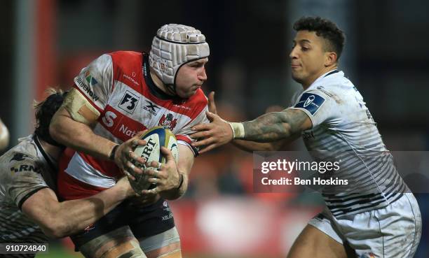 Ben Morgan of Gloucester is tackled by Jay Baker of Ospreys during the Anglo-Welsh Cup match between Gloucester Rugby and Ospreys at Kingsholm...