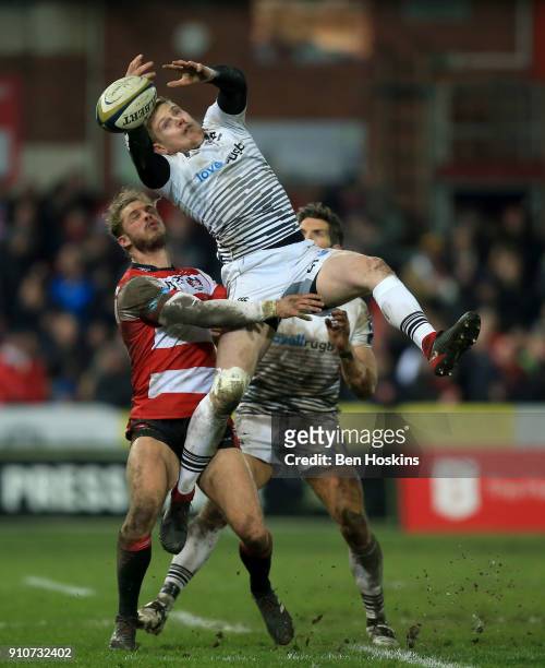Dafydd Howells of Ospreys beats Henry Purdy of Gloucester to the ball during the Anglo-Welsh Cup match between Gloucester Rugby and Ospreys at...