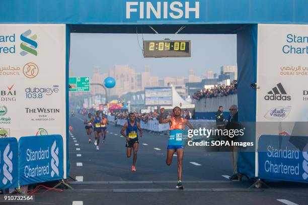 Mosinet Geremew of Ethiopia crosses the line to win the Standard Chartered Dubai Marathon 2018 in a new course record time of 2:04:00.