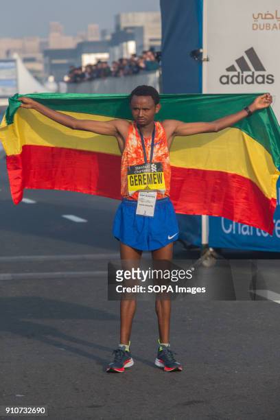 Mosinet Geremew of Ethiopia celebrates his win the Standard Chartered Dubai Marathon 2018 in a new course record time of 2:04:00.