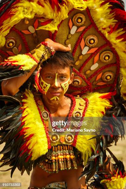 tribesman carrying his native head dress at the festival - dinagyang festival stock pictures, royalty-free photos & images