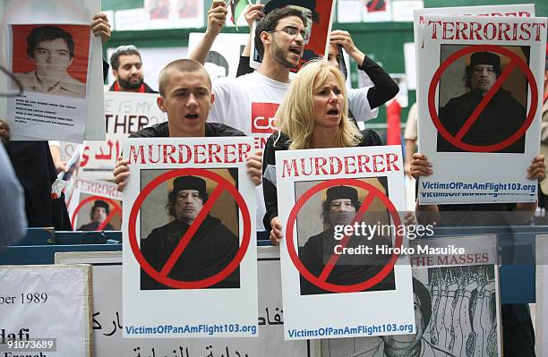 Protesters demonstrate against Libyan leader Muammar al-Gaddafi outside the United Nations headquarters during the 64th United Nations General...