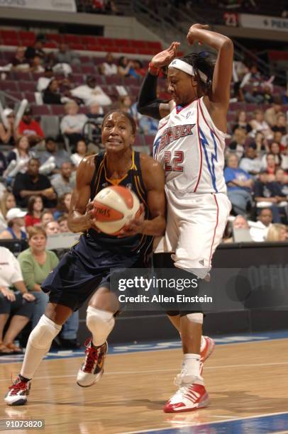 Tamika Catchings of the Indiana Fever drives around Alexis Hornbuckle of the Detroit Shock in Game One of the WNBA Eastern Conference Finals on...