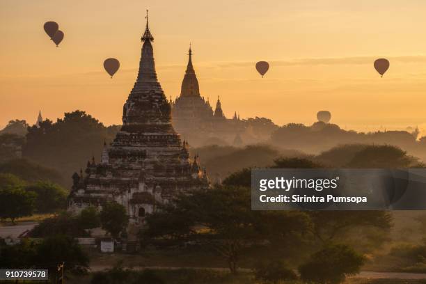 hot-air balloons flying over ananda temple at early morning, bagan, myanmar - bagan temples damaged in myanmar earthquake stock pictures, royalty-free photos & images