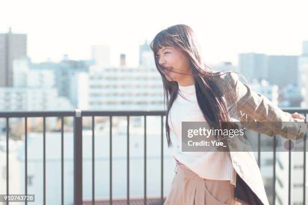 young woman outside on sunny winter day - tokyo fashion stock pictures, royalty-free photos & images