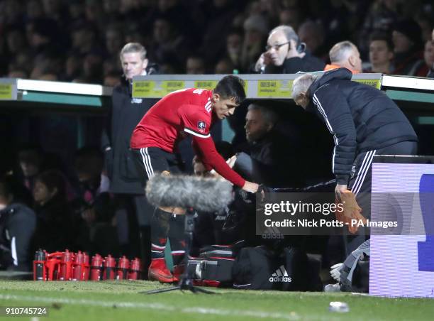 Manchester United's Alexis Sanchez in the dugout as Manchester United manager Jose Mourinho looks on during the Emirates FA Cup, fourth round match...