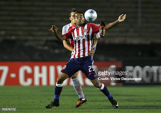 Maicon Santos of Chivas USA and Aaron Galindo of Chivas de Guadalajara vie for the ball in the first half during the International Club Friendly at...