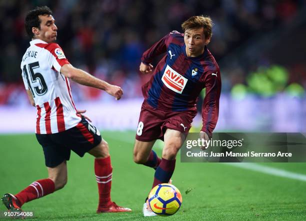 Takashi Inui of SD Eibar being followed by Inigo Lekue of Athletic Club during the La Liga match between Athletic Club and Eibar at Estadio San Mames...