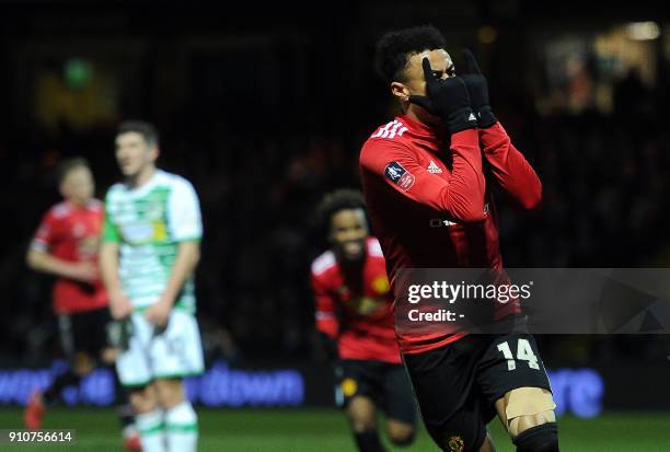 Manchester United's English midfielder Jesse Lingard reacts after scoring the team's third goal during the FA Cup fourth round football match between...
