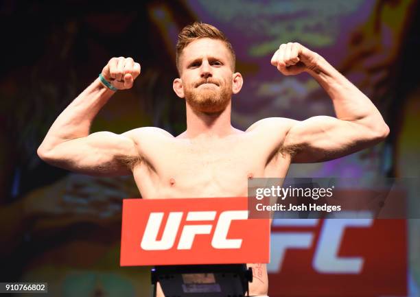 Austin Arnett poses on the scale during a UFC Fight Night weigh-in on January 26, 2018 in Charlotte, North Carolina.