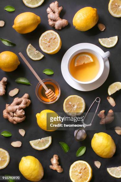 a cup of lemon ginger honey tea on rustic wooden background. - tea leaves 個照片及圖片檔
