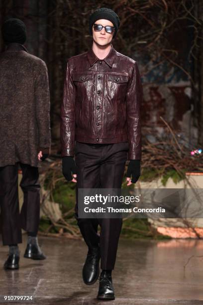 Model walks the runway wearing John Varvatos Fall/Winter 2018 with makeup by Chika Chan for Make-Up Pro and Hair by Yannik D'Is for Cultler/Redken at...