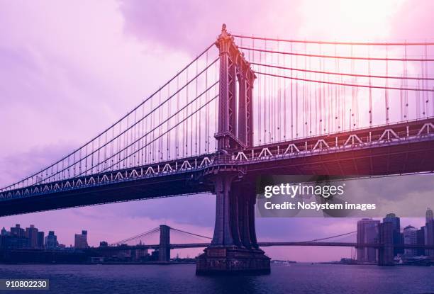 manhattan bridge new york city at sunset. brooklyn bridge in background - manhattan bridge stock pictures, royalty-free photos & images