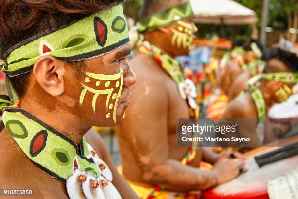 tribesman playing drums at festival - dinagyang festival stock pictures, royalty-free photos & images