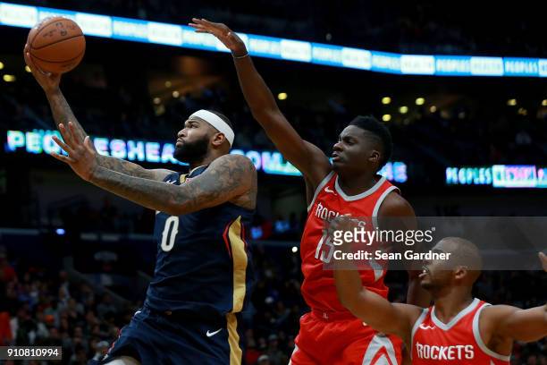 DeMarcus Cousins of the New Orleans Pelicans shoots over Clint Capela of the Houston Rocketsduring the first half at the Smoothie King Center on...