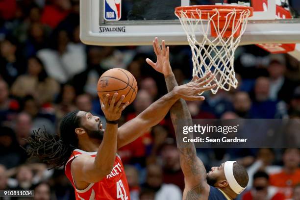 Nene Hilario of the Houston Rockets shoots over DeMarcus Cousins of the New Orleans Pelicans during the first half at the Smoothie King Center on...