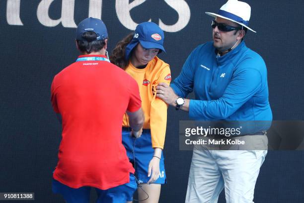 Ballkid is helped from the court after struggling in the heat during the Australian Open 2018 Junior Championships at Melbourne Park on January 27,...