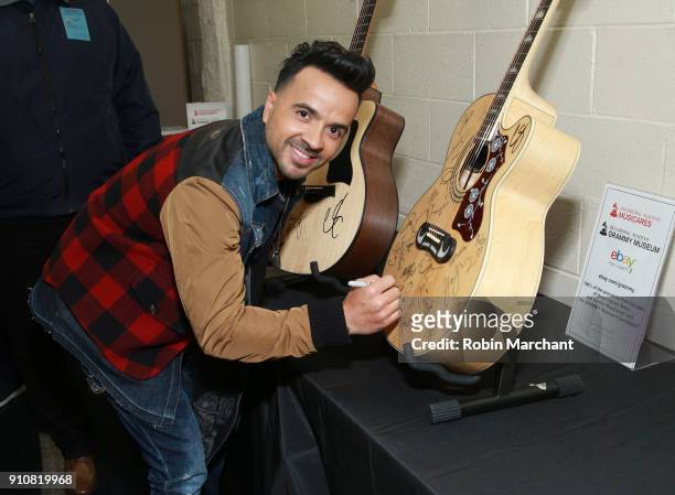 Singer-songwriter Luis Fonsi poses with the GRAMMY Charities Signings during the 60th Annual GRAMMY Awards at Madison Square Garden on January 26,...