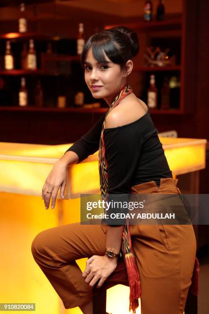 This picture taken on January 26, 2018 shows Indonesian news anchor Angie Ang posing during a promotional event in Jakarta. / AFP PHOTO / OEDAY...