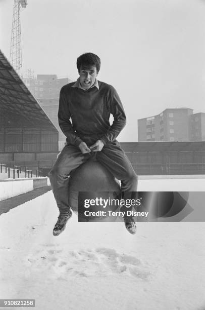 British soccer player and striker Geoff Hurst of West Ham United FC trying a bouncing ball on a snowy pitch, London, UK, 13th January 1968.