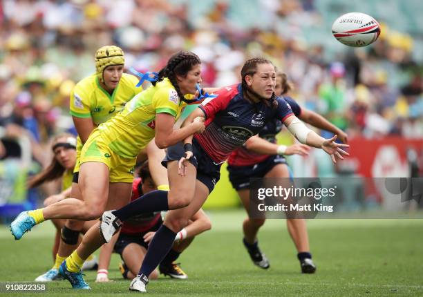 Arina Bystrova of Russia offloads the ball in a tackle from Charlotte Caslick of Australia in the Cup semi final match during day two of the 2018...