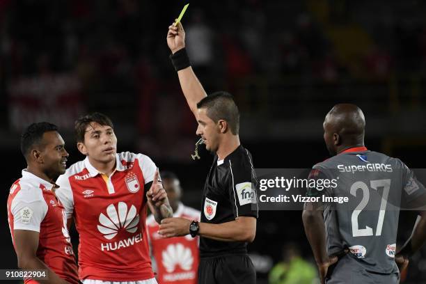 Referee Oscar Gomez, shows the yellow card to Armando Vargas of Independiente Santa Fe during the match between Independiente Santa Fe and America de...