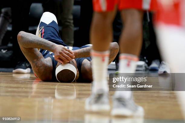 DeMarcus Cousins of the New Orleans Pelicans lies down on the ground after injuring his ankle during the second half of a NBA game against the...