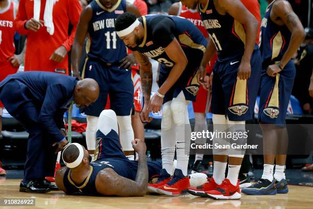 DeMarcus Cousins of the New Orleans Pelicans lies down on the ground after injuring his ankle during the second half of a NBA game against the...