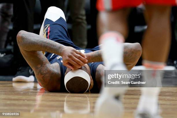 DeMarcus Cousins of the New Orleans Pelicans lies down on the ground after injuring his ankle during the second half of a NBA game against the...