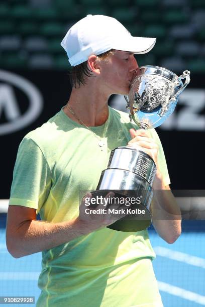 Sebastian Korda of the United States poses with the championship trophy after winning his Junior Boys' Singles Final against Chun Hsin Tseng of...