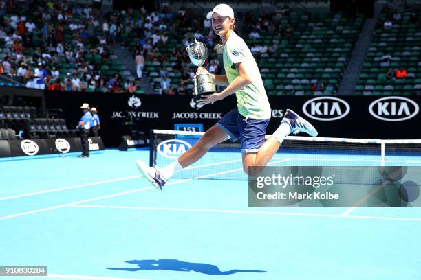 Sebastian Korda of the United States poses with the championship trophy after winning his Junior Boys' Singles Final against Chun Hsin Tseng of...