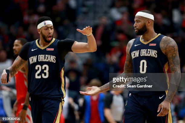 Anthony Davis of the New Orleans Pelicans and DeMarcus Cousins of the New Orleans Pelicans react after scoring against the Houston Rockets during the...