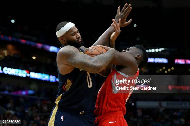 DeMarcus Cousins of the New Orleans Pelicans fights for a loose ball with Clint Capela of the Houston Rockets during the second half at the Smoothie...