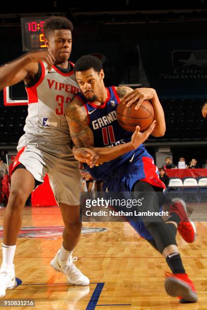 McDaniels of the Grand Rapids Drive moves the ball past George de Paula of the Rio Grande Valley Vipers during an NBA G-League game on January 26,...