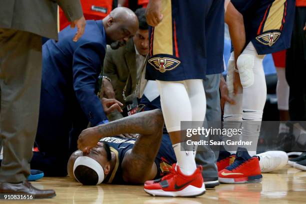 DeMarcus Cousins of the New Orleans Pelicans lies down on the ground after injuring his ankle during the second half of a NBA game against the...