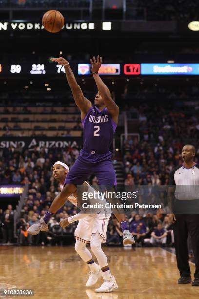 Isaiah Canaan of the Phoenix Suns attempts a shot over Trey Burke of the New York Knicks during the second half of the NBA game at Talking Stick...