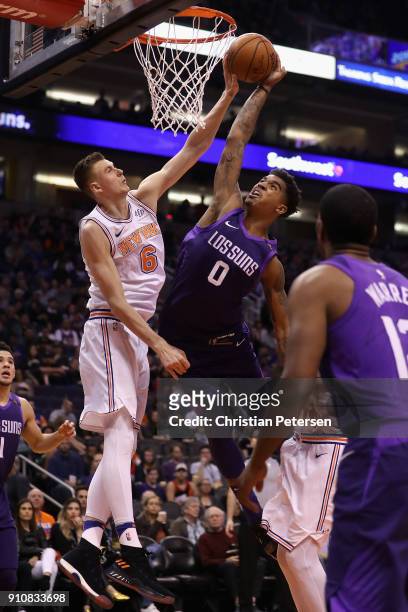 Marquese Chriss of the Phoenix Suns is blocked as he attempts a slam dunk against Kristaps Porzingis of the New York Knicks during the second half of...