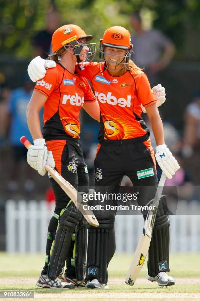 Lauren Ebsary of the Perth Scorchers celebrates her 50 with team mate Piepa Cleary during the Women's Big Bash League match between the Melbourne...