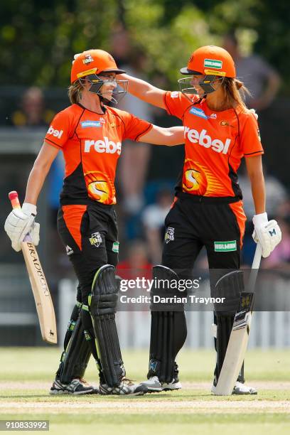 Lauren Ebsary of the Perth Scorchers celebrates her 50 with team mate Piepa Cleary during the Women's Big Bash League match between the Melbourne...