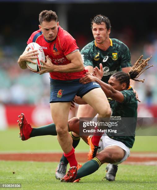 Igor Genua of Spain is tackled in the game against South Africa during day two of the 2018 Sydney Sevens at Allianz Stadium on January 27, 2018 in...