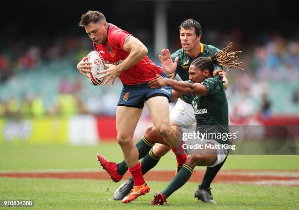 Igor Genua of Spain is tackled in the game against South Africa during day two of the 2018 Sydney Sevens at Allianz Stadium on January 27, 2018 in...