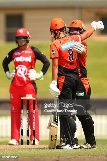 Lauren Ebsary of the Scorchers celebrates making 50 runs with team mate Piepa Cleary of the Scorchers during the Women's Big Bash League match...