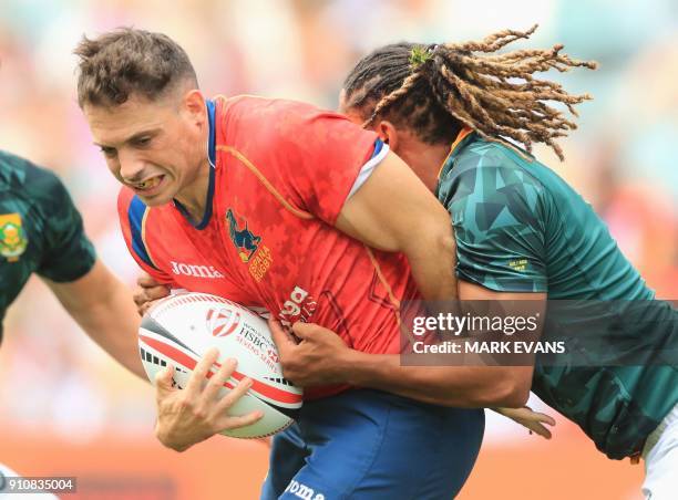Igor Genua of Spain is tackled by Justin Geduld of South Africa during the Sydney World Rugby Sevens Series tournament in Sydney on January 27, 2018....