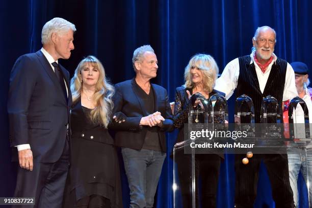 Former President Bill Clinton, Honorees Stevie Nicks, Lindsey Buckingham, Christine McVie and Mick Fleetwood pose onstage during MusiCares Person of...