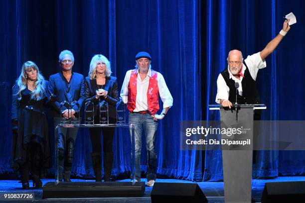 Honorees Stevie Nicks, Lindsey Buckingham, Christine McVie, John McVie listen as Mick Fleetwood speaks onstage during MusiCares Person of the Year...